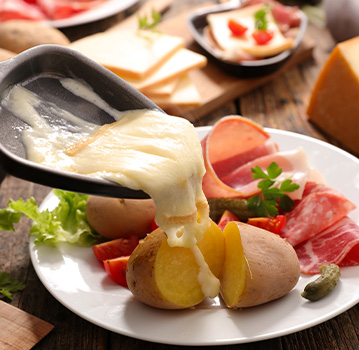 Raclette pouring on potatoes